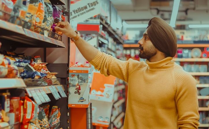 man shopping for crisps